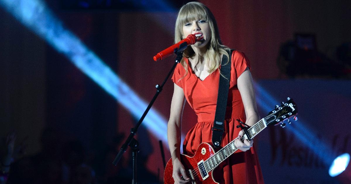 Taylor Swift performing in London wearing a red dress.