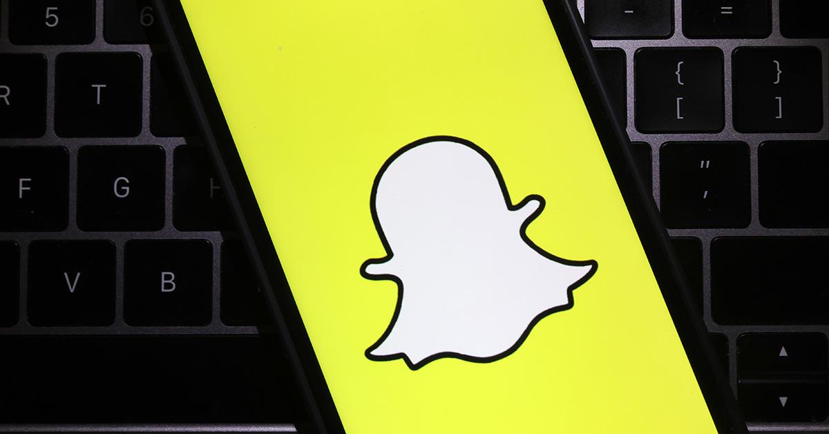 A full screen Snapchat logo on a phone. 