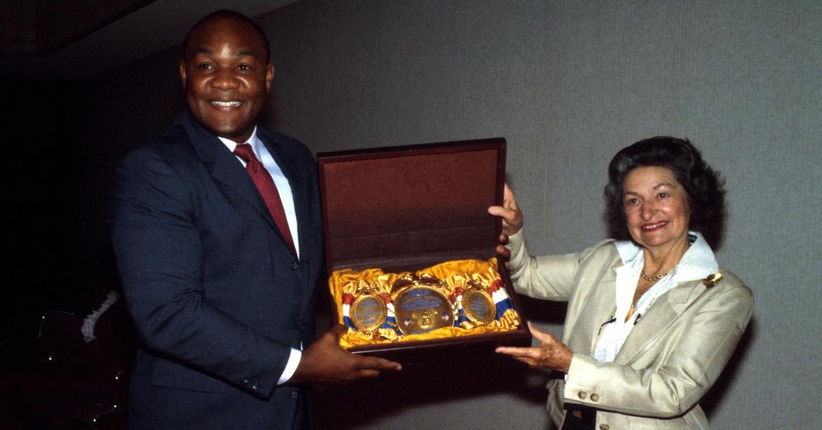 Former first lady Lady Bird Johnson with heavyweight champion George Foreman. 