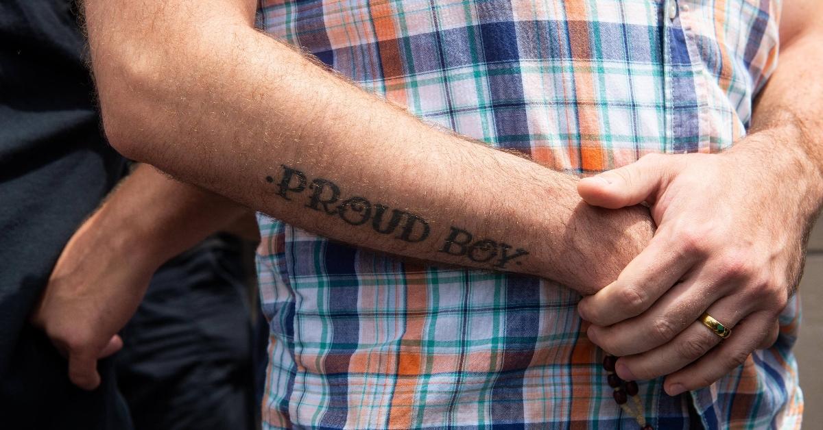  A man with a ''Proud Boys'' tattoo observes a protest calling for the statue of St. Louis to be removed from Forest Park