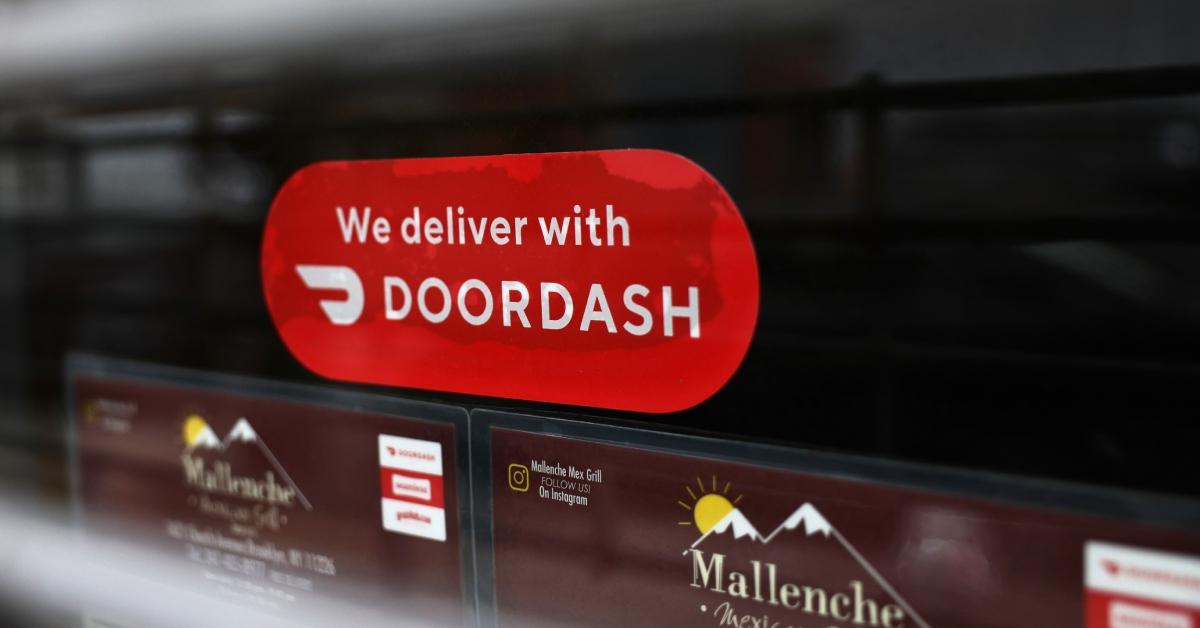 A Doordash sticker is seen on a window