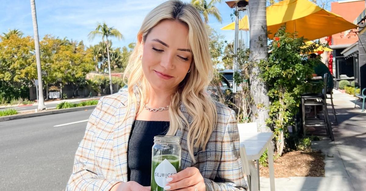 Selling Sunset star Gio Helou's wife Tiffany Helou sitting outside drinking green juice