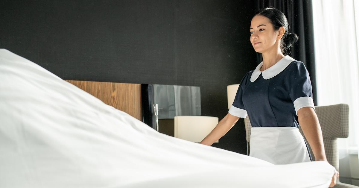 Housekeeper changing sheets