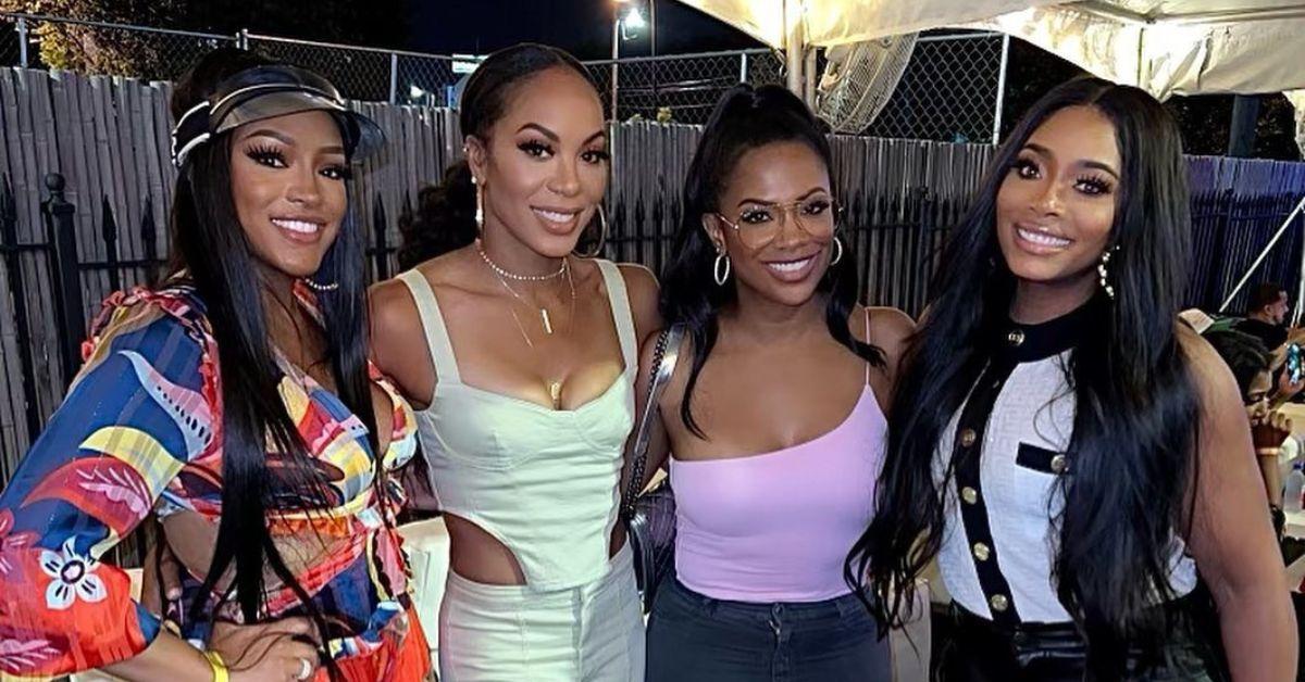 (l-r): Drew Sidora, Sanya Richards-Ross, Kandi Burruss, and Yandy Smith posing together at an event. 