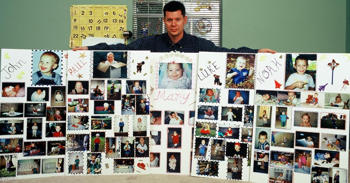 Rusty Yates stands behind photos of his children