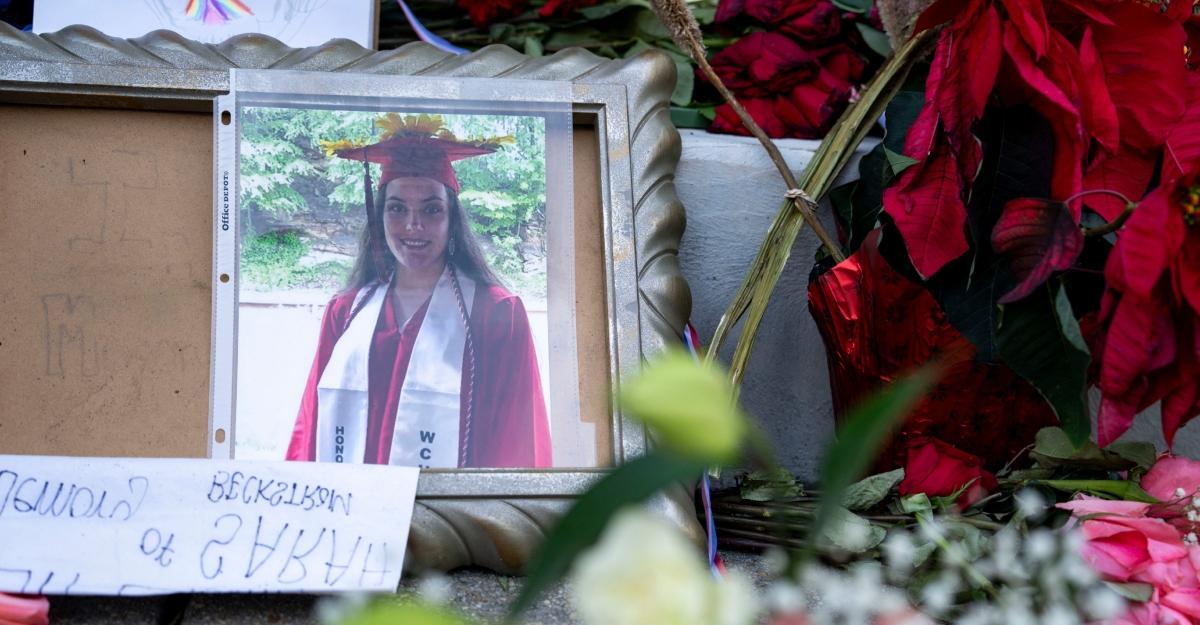 A photo placed at fallen National Guard Member Sarah Beckstrom's memorial shows her graduating.