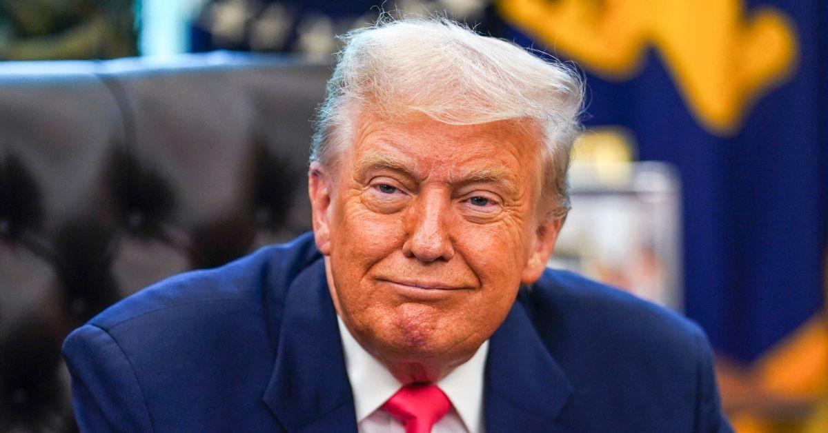 Donald Trump smiling in the Oval Office. 