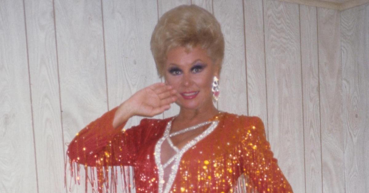 Mitzi Gaynor in an orange sequined outfit.