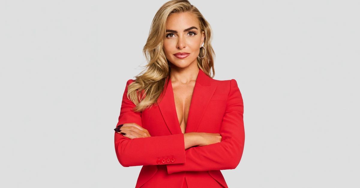 Eleonora Srugo in a red outfit with her arms folded 