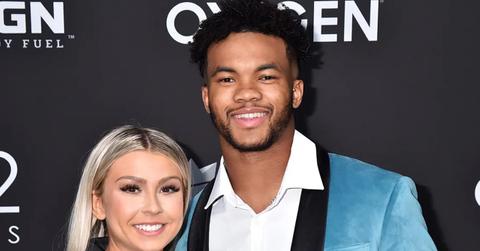 Kyler Murray in a blue suit at a Sports Illustrated event with a blond woman