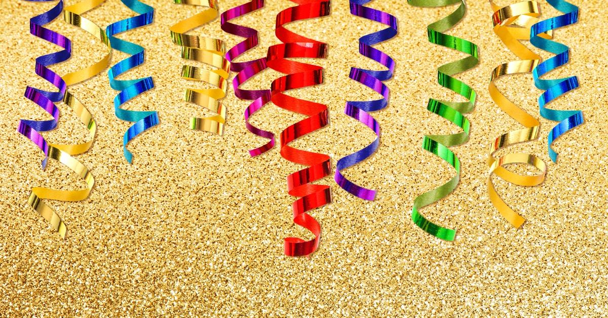 colorful streamer over golden shiny background. party decoration