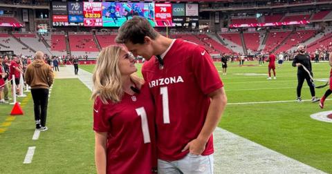 Matt and Abby Howard pose on the Arizona Cardinals' football field