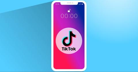 The TikTok logo is displayed on a mobile phone.