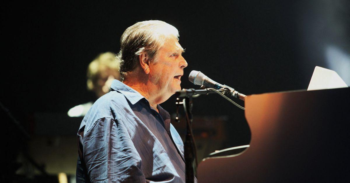 Brian Wilson performing on stage. 