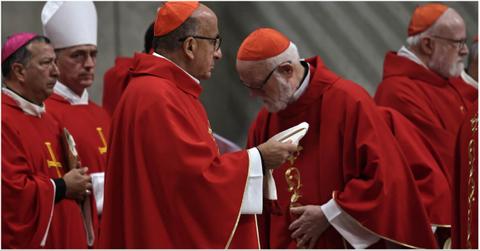 Cardinals wearing different hats