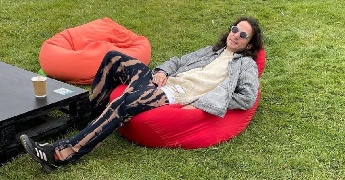 Luis Felber sitting on a red bean-bag chair.