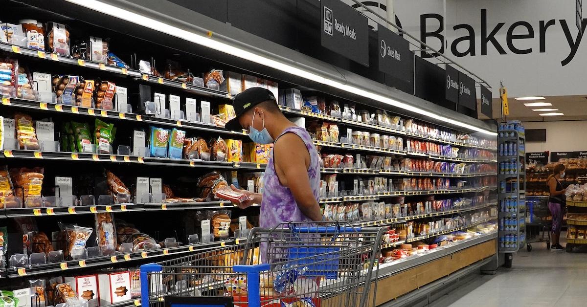 A person shopping the Walmart's ready-made food aisle