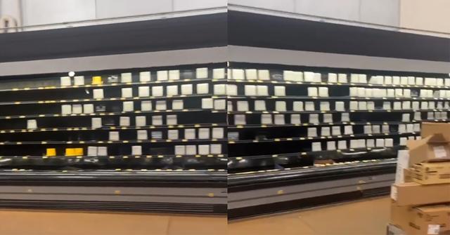 A customer shows empty grocery shelves due to trucker strike