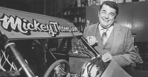 Mickey Thompson stands in his garage by a singleseat offroad racer in Sept. 1986