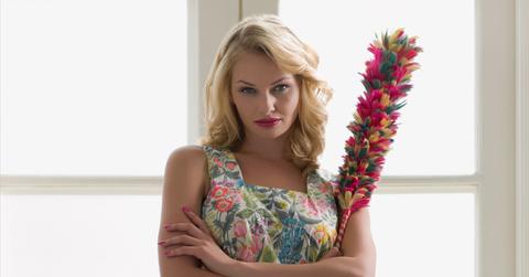 A trad wife holding a duster