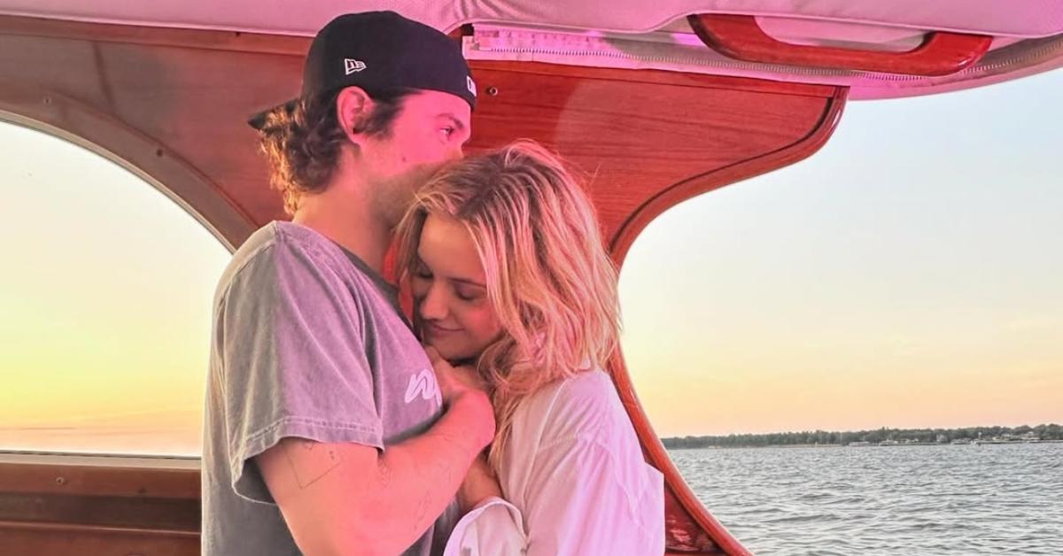 Chase and Kelsea snuggling on a boat together.