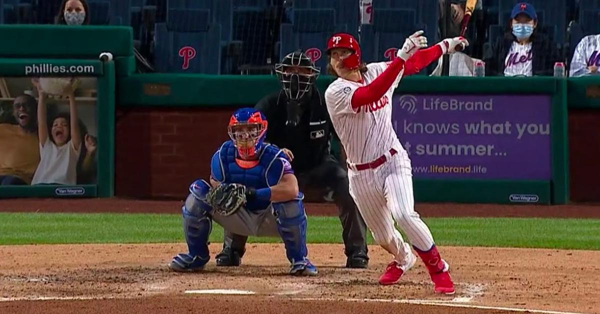Alec Bohm mid-swing at Citizens Bank Park, capturing the moment before his hand injury forced him from the lineup