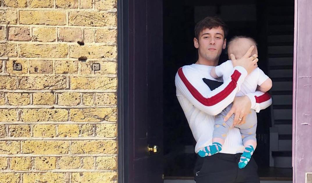 Tom Daley and Dustin Lance Black look besotted with baby son on stroll ...