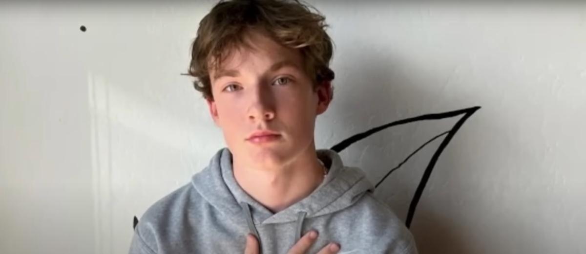 16-year-old Adam Raine poses in front of a wall in his home.