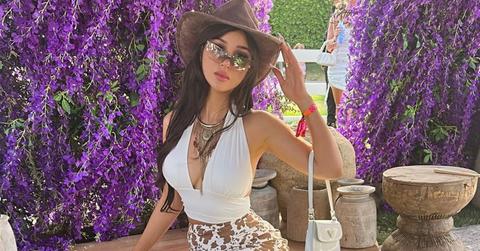 SSSniperwolf sitting in front of a wall of lavender