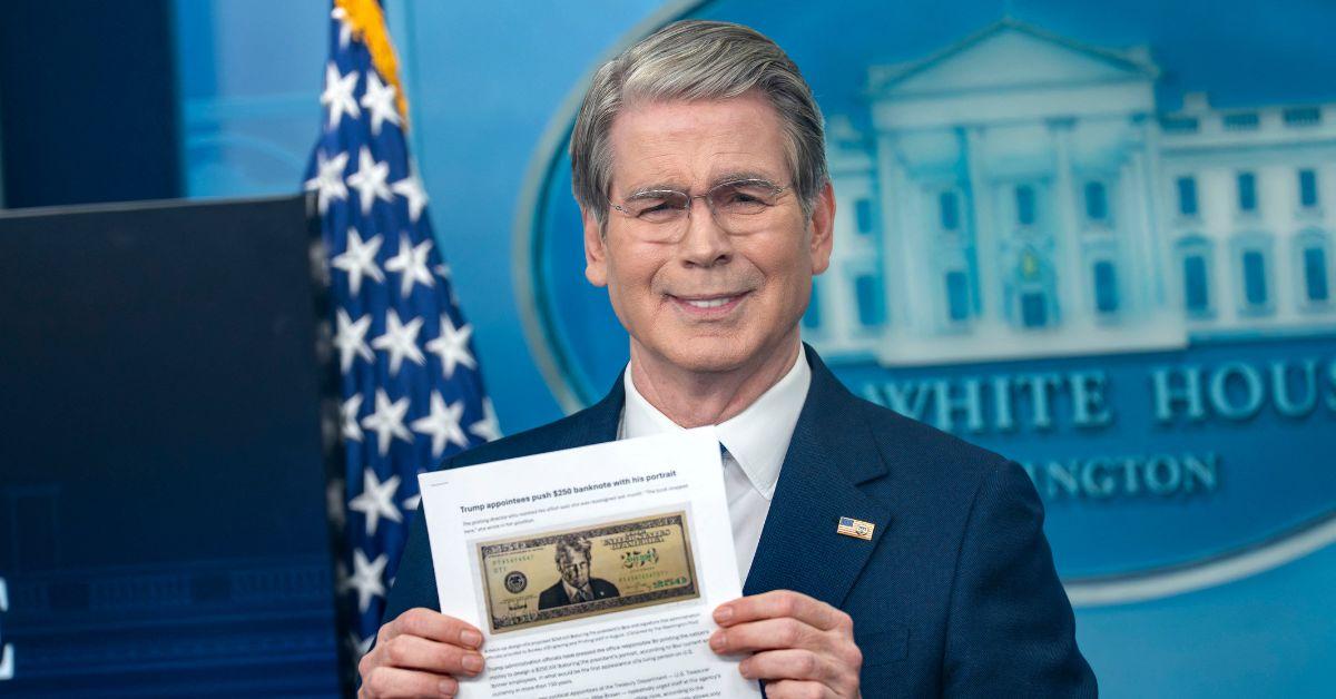 Scott Besssent holding up a mockup of the Trump 250 dollar bill.