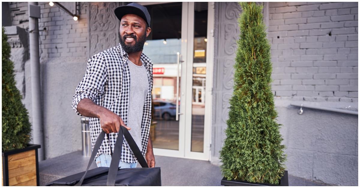 A delivery driver with a bag in his hand