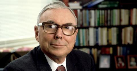 Charlie Munger sitting in front of a bookcase.