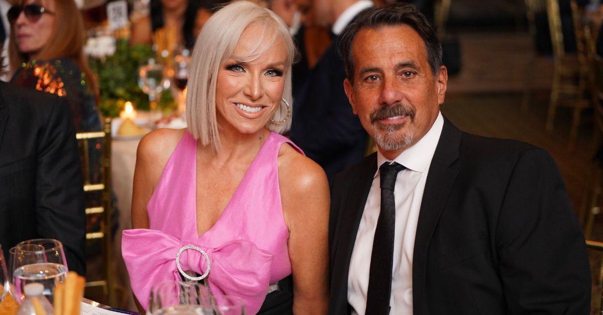 Margaret Josephs and Joe Benigno pose for photo seated at a table at a formal event.