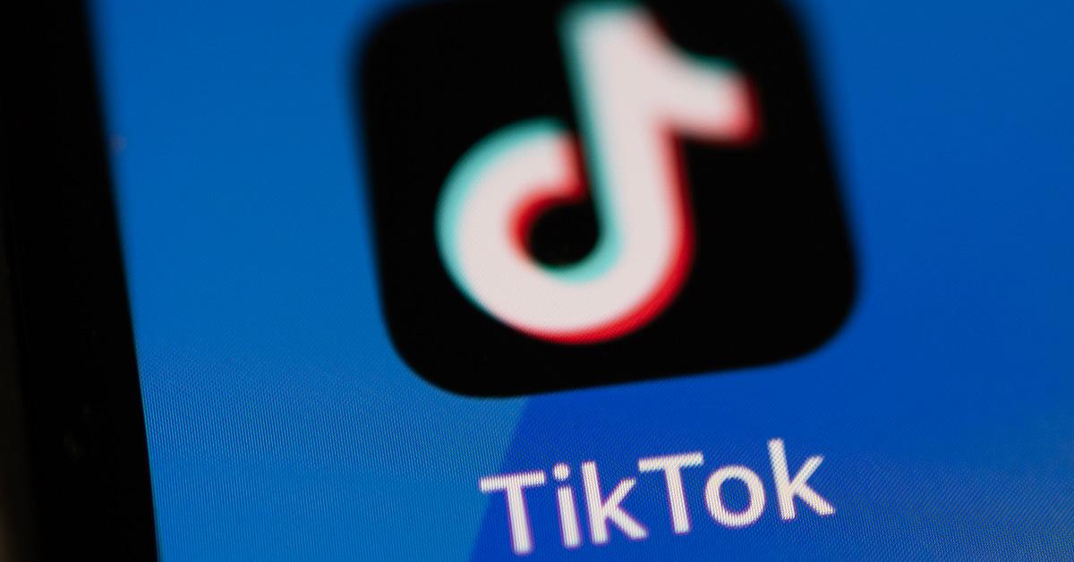 The TikTok logo on a phone screen up close. 