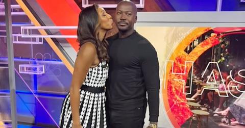 Maria Taylor and her husband sharing a kiss