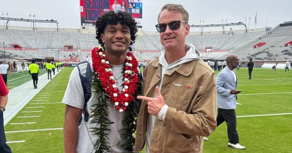 Lane Kiffin with a player on the Ole Miss field.