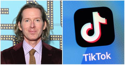 wes anderson in a ruby velour suit with a beige tie