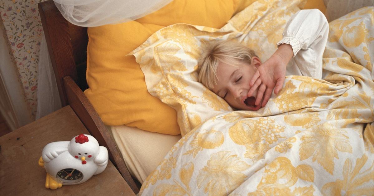 A young girl sleeping in her bed.