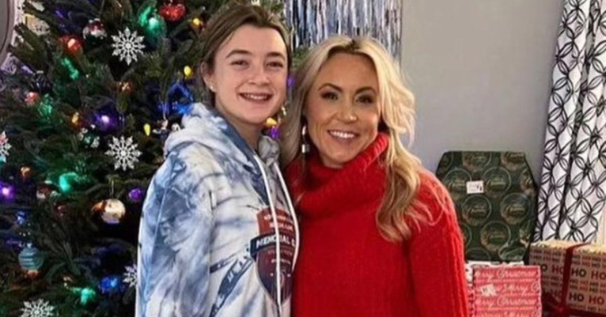 Ava wood and Heather Wood smile in front of their Christmas tree