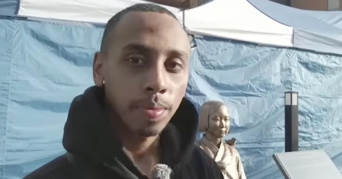 Johnny Somali standing next to the Statue of Peace in South Korea.