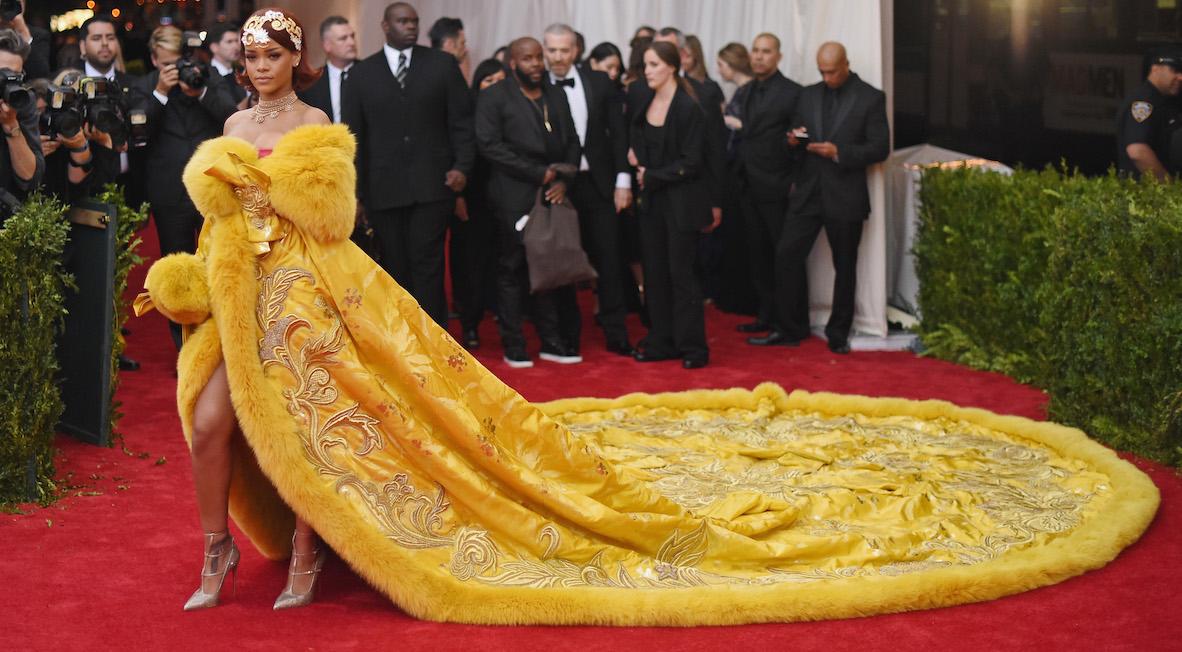 Rihanna posing in a golden dress