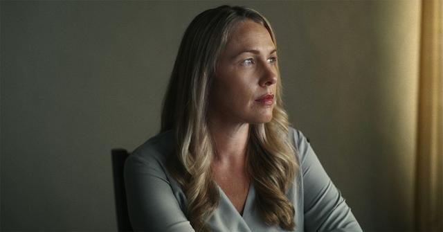 Denise Huskins looking out a window in 'American Nightmare.'