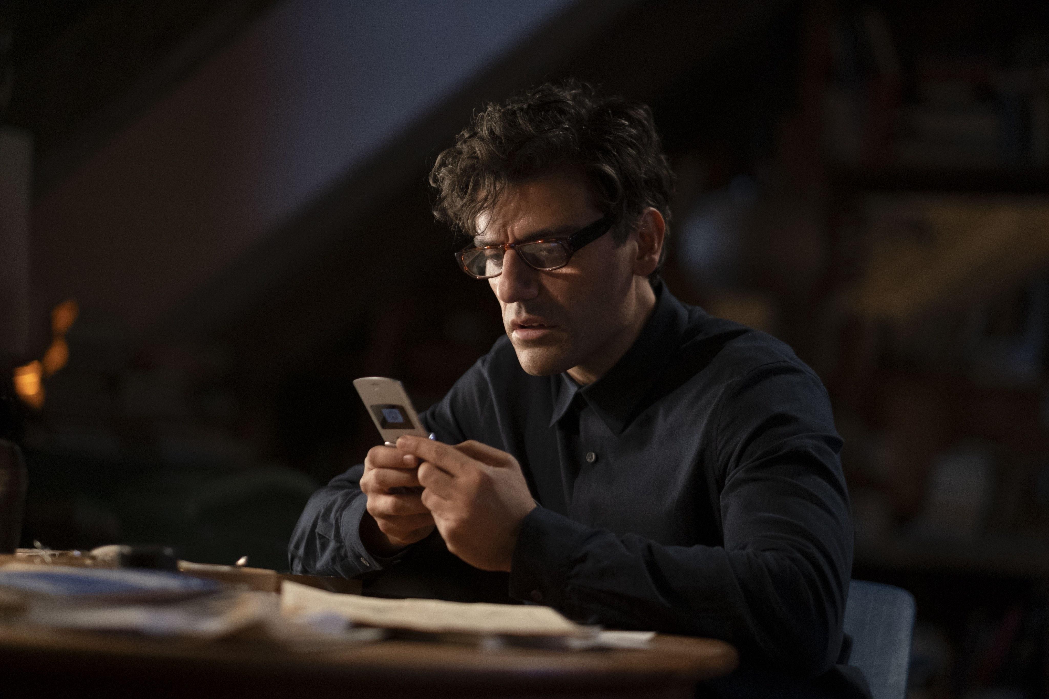 Oscar Isaac as Steven Grant using a flip phone in 'Moon Knight.'