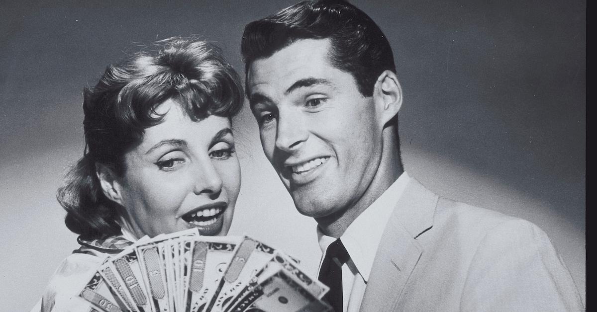 A woman and man looking at money