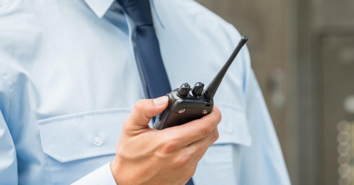 security guard holding walkietalkie picture id