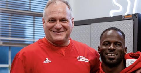 Rich Rodriguez standing with one of his players