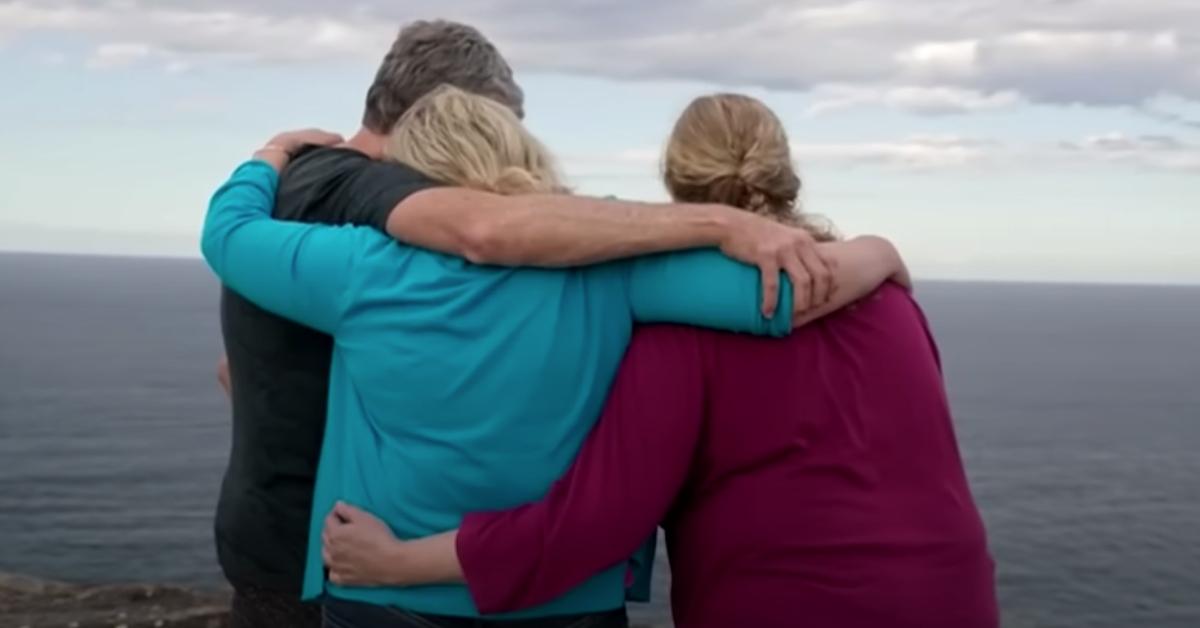 The Johnson family hugs each other on the cliff where Scott Johnson was murdered