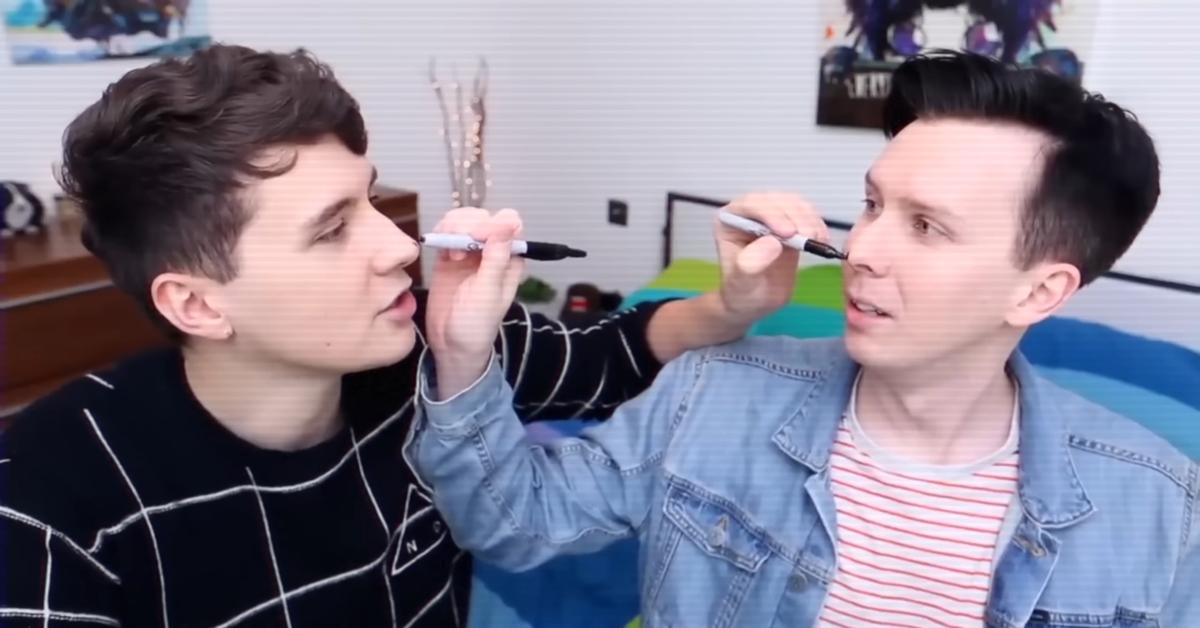 YouTubers Dan and Phil drawing on each other's faces
