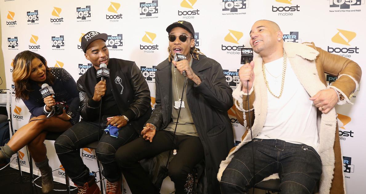 Angela Yee, Charlamagne Tha God, and DJ Envy interviewing Wiz Khalifa. 