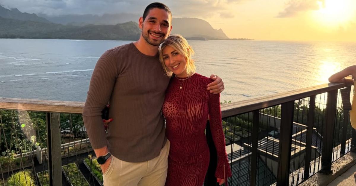 Alan Bersten and Emma Slater on a patio overlooking the ocean.